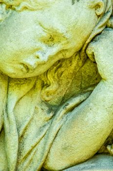 detail of a mourning sculpture on a cemetery