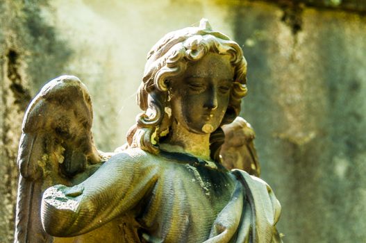 detail of a mourning sculpture on a cemetery