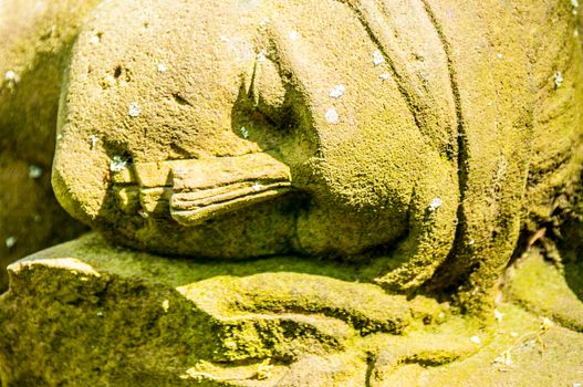 detail of a mourning sculpture on a cemetery