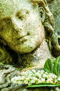 detail of a mourning sculpture on a cemetery