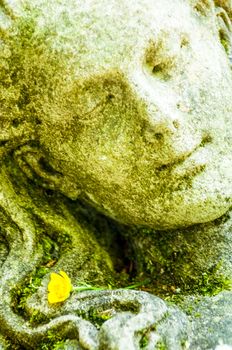 detail of a mourning sculpture on a cemetery