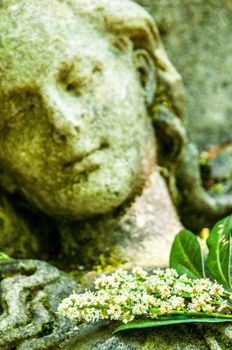 detail of a mourning sculpture on a cemetery