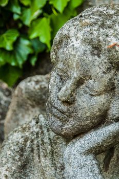 detail of a mourning sculpture on a cemetery