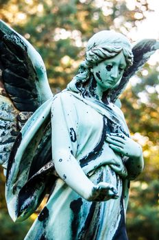 detail of a mourning sculpture on a cemetery