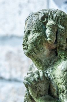 detail of a mourning sculpture on a cemetery