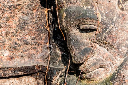 detail of a mourning sculpture on a cemetery