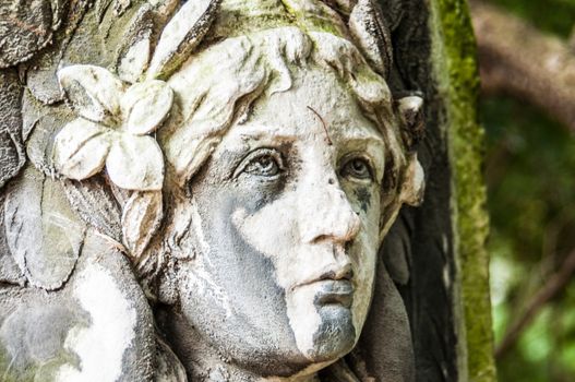 detail of a mourning sculpture on a cemetery