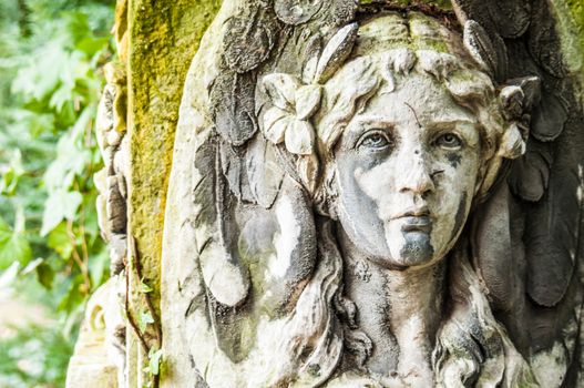 detail of a mourning sculpture on a cemetery