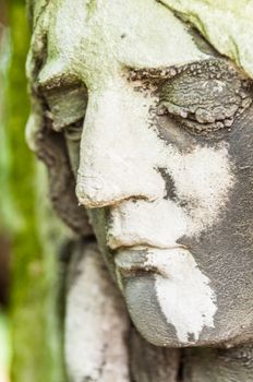 detail of a mourning sculpture on a cemetery