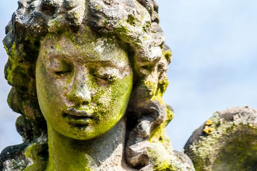 detail of a mourning sculpture on a cemetery