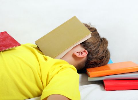 Tired Teenager sleep on the Books