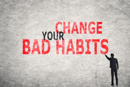 Asian businessman write text on wall, Change Your Bad Habits
