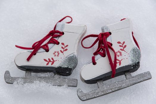A pair of ice skate ornaments in snow