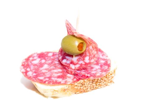 Slice of bread with salami and olive over white background