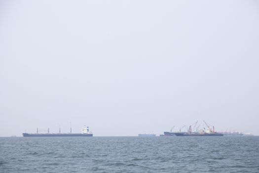 Large cargo ship Boats moored in the sea to make sense compared to the coast.