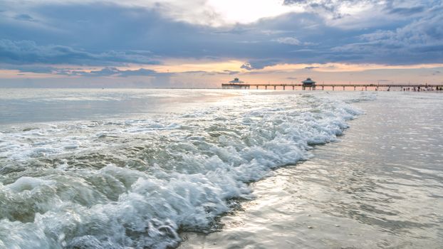 The beautiful sun setting on the shores of Fort Myers Beach located on Estero Island in Florida, United States of America