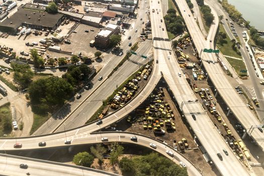 Aerial view of the Borough of Queens, New York, showing densely packed buildings and a multi-lane super highway