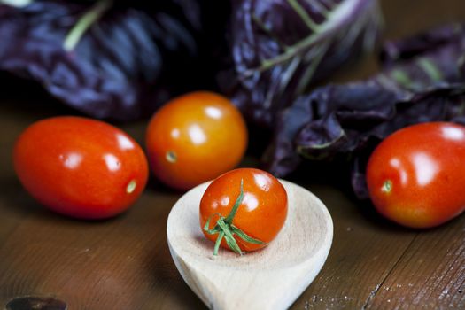 Fresh tomato and red chicory with wooden spoon