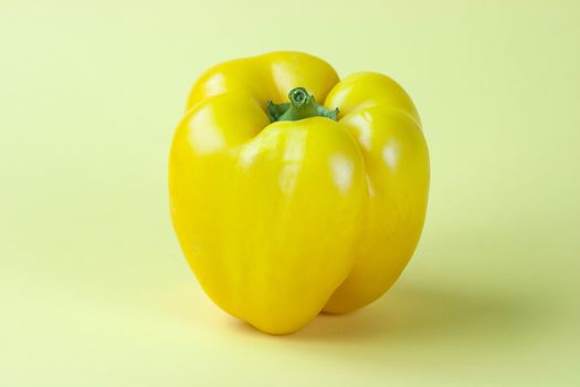 Sweet yellow pepper isolated on yellow background