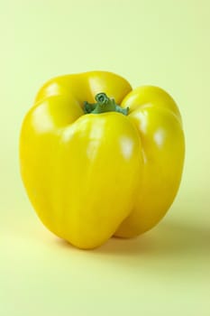 Sweet yellow pepper isolated on yellow background