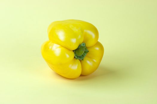 Sweet yellow pepper isolated on yellow background