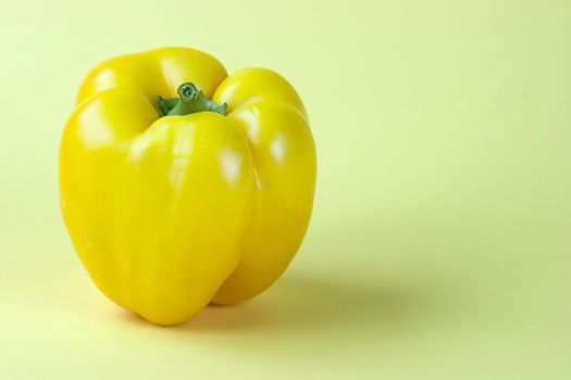 Sweet yellow pepper isolated on yellow background