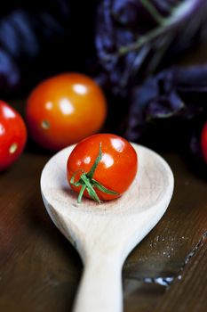 Fresh tomato and red chicory with wooden spoon