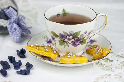 English afternoon tea with cookies and candied violets