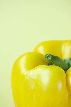 Sweet yellow pepper isolated on yellow background