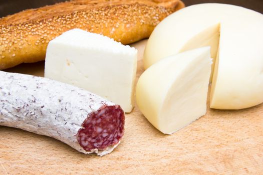 Cheeses seen up close on chopping board