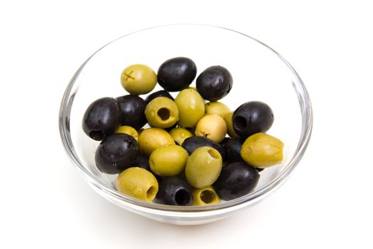 Green and black olives on bowl on white background