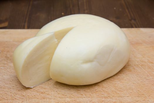 Italian cheese on wooden cutting board