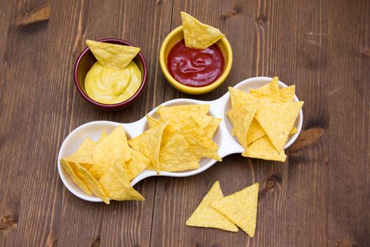 Nachos on wooden table seen from above