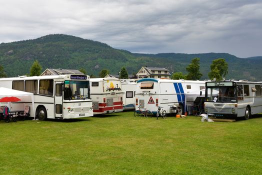 Byglandsfjord, Norway – June 8, 2014: The Norwegian way of camping with restyled coaches used as campers in Byglandsfjord, Norway on June 8, 2014.