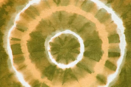 orange abstract pattern on tie dyed cotton fabric