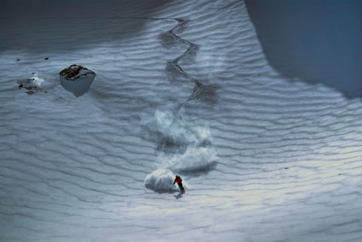 Amazing view of a skier riding down the piste                