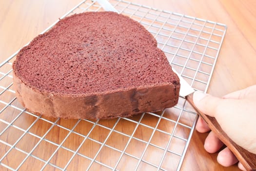 cutting chocolate cake on layers, making chocolate cake.