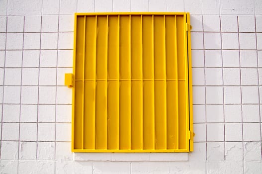 Urban design yellow shutter on white wall