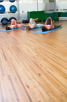 Yoga class stretching in fitness studio at the leisure center