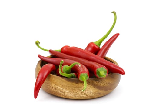 chili peppers in a bowl on white background