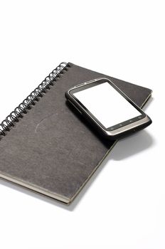 smartphone on note book on a white background