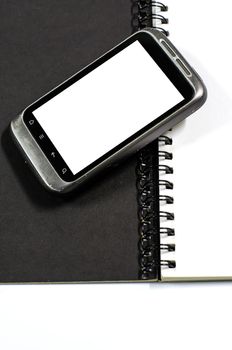 smartphone on note book on a white background