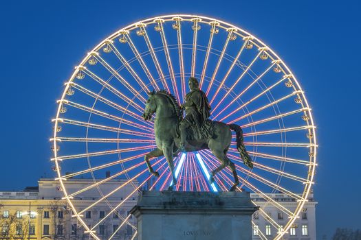 Place Bellecour statue of King Louis XIV by night, Lyon France 