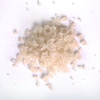 Heap of sea salt on a white background