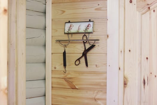 Vintage composition on the background of a wooden wall. Hanger, scissors, scales