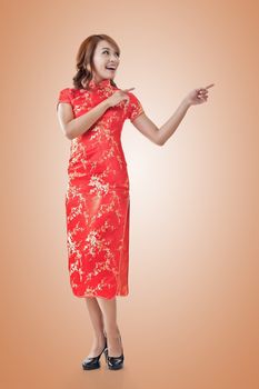 Chinese woman dress traditional cheongsam at New Year and introducing, full length portrait isolated.