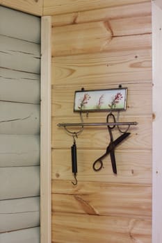 Vintage composition on the background of a wooden wall. Hanger, scissors, scales