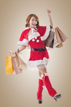 Asian Christmas girl hold shopping bags, full length portrait.