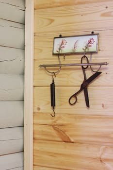 Vintage composition on the background of a wooden wall. Hanger, scissors, scales