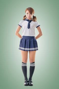 Japanese style school girl in sailor suit, full length portrait.